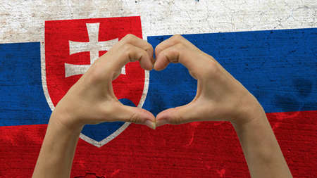With a stylized Slovakia flag background an anonymous person's hands being held in the form of a heart, symbolizing love and patriotism for Slovakia.の写真素材