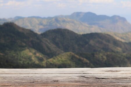 old wood table with green mountain backgroundの写真素材