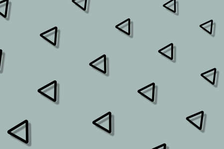 Pattern of black geometric shapes in retro, memphis 80s 90s style. Triangles shapes on grey background with shadows. Vintage abstract backgroundの写真素材