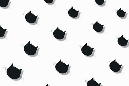 Colorful pattern of black cat heads on white background with shadows. Seamless pattern with cat faces. Top viewの写真素材