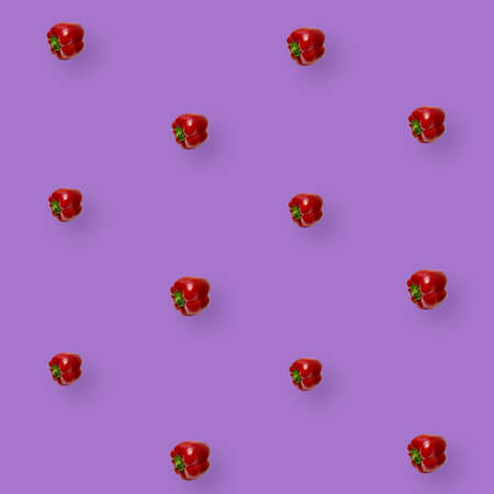 Colorful pattern of fresh paprika on violet background. Bulgarian red pepper. Top view. Flat lay. Pop art designの写真素材