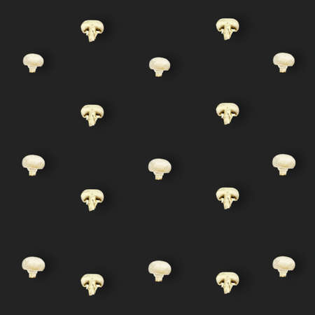 Colorful pattern of fresh mushrooms on black background. Champignon sliced. Top view. Flat lay. Pop art designの写真素材
