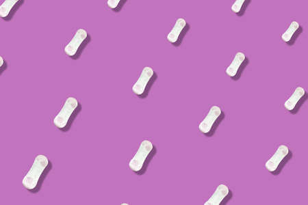 Colorful pattern of daily womens sanitary pads on pink background with shadows. Menstrual pad. Top...