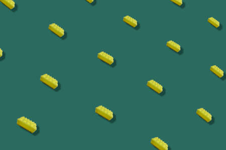 Colorful pattern of yellow kitchen sponges on green background with shadows. Top view. Flat lay. Pop art designの写真素材