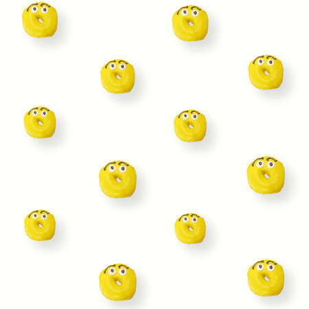 Colorful pattern of yellow glazed donuts isolated on white background with shadows. Doughnuts. Top view. Flat layの写真素材