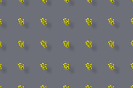 Colorful fruit pattern of fresh grapes on grey background. Top view. Flat lay. Pop art design