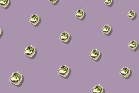 Colorful pattern of japanese sushi rolls on purple background with shadow. Top view. Flat lay. Pop art designの写真素材