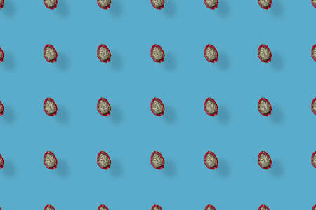 Colorful pattern of fresh dragon fruit on blue background with shadows. Pitaya. Top view. Flat lay. Pop art designの写真素材