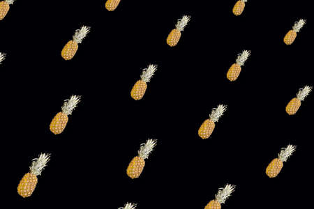 Colorful fruit pattern of pineapples on black background. Top view. Flat lay. Pop art design