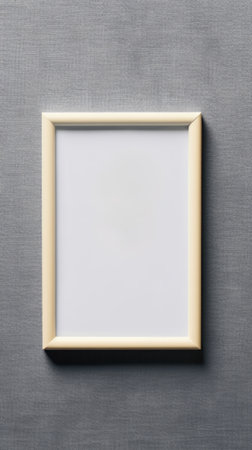 A blank white picture frame hanging on a wallの素材