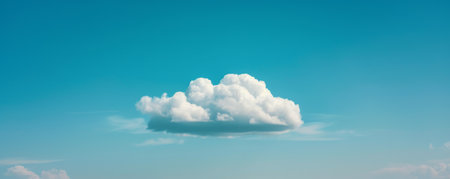 Solitary white cloud in a clear blue skyの素材