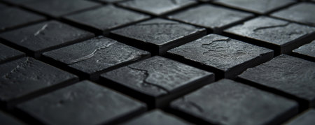 Close-up of textured black tiles, abstract backgroundの素材