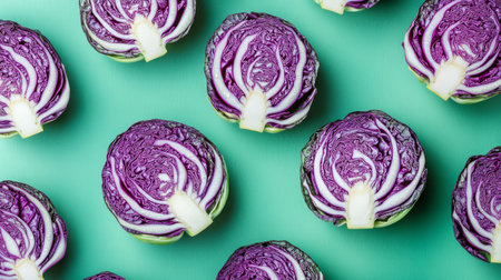 Purple cabbages sliced in half on turquoise background, top view. Fresh vegetable and healthy eating conceptの素材