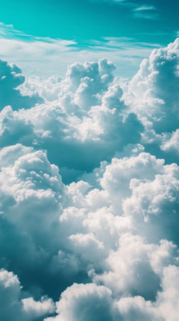 Fluffy white clouds in bright blue sky, aerial view. Dreamy and serene nature conceptの素材