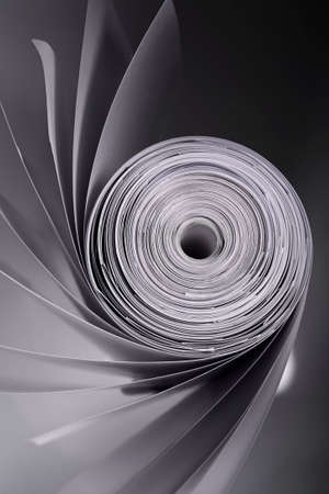 Rolled abstracted textured beaty grey pages on the black and grey background isolated in studioの写真素材