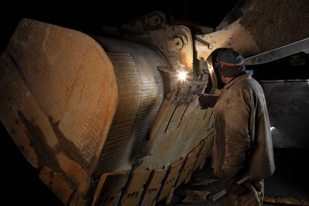 Welder welding a part in a factory