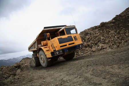 yellow big heavy truck driving on the road