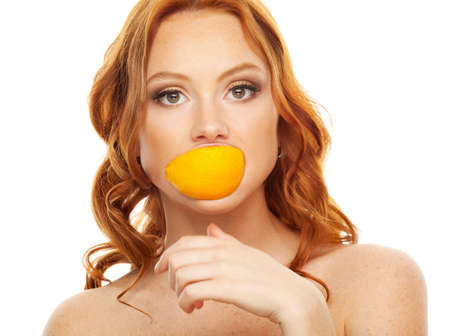 Beauty model with slice of orangeの写真素材