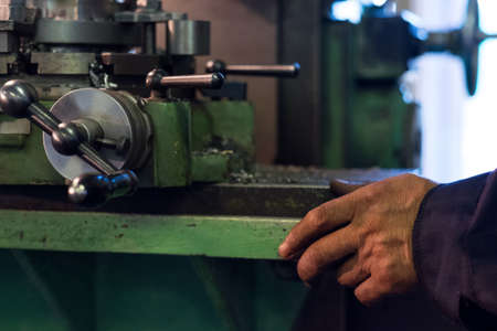Worker manipulate old machine on factory, soft focusの写真素材