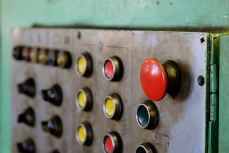 Panel with buttons and red big button on factoryの写真素材