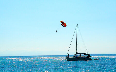 Colored parachute over a boat in the sea in Zante, Greeceの写真素材