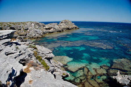 Rocky cliff with crystal blue sea waterの写真素材