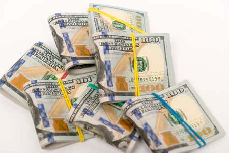 Packs of hundred dollar banknotes with rubber bandsの写真素材