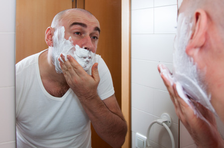 Man shaving in front a mirrorの写真素材