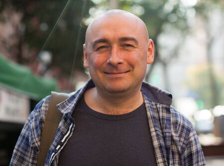 Smiling man in a plaid shirtの写真素材