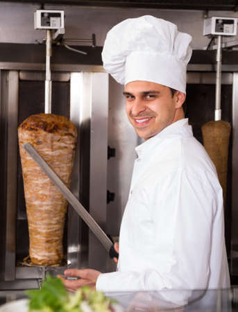 Portrait of caucasian male chef with kebab at fastfood cafeの写真素材