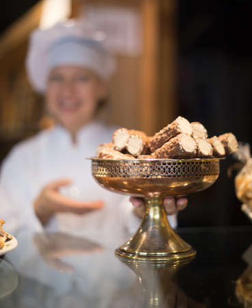 women selling tarts and sweet pastry in coffee-houseの写真素材