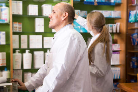 Team of pharmaceutist and technician working in chemist shopの写真素材