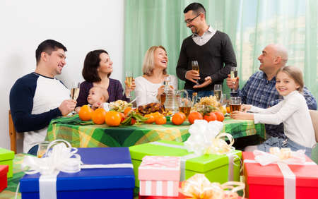 Mature man celebrating jubilee with big family at festive tableの写真素材
