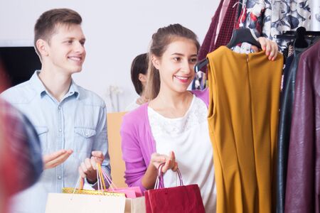A young couple in a boutique chooses dressの写真素材