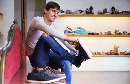 Man with the shoes in their handsの写真素材