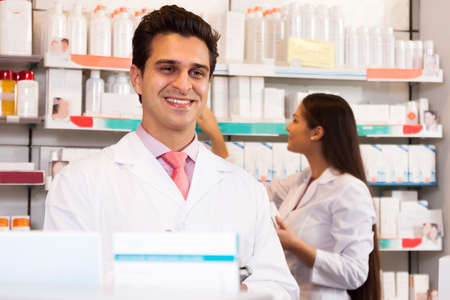 Smiling man seller at the chemists shopの写真素材