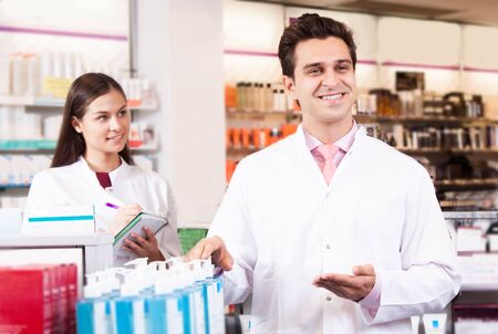 Man and woman pharmacists at the chemists shopの写真素材