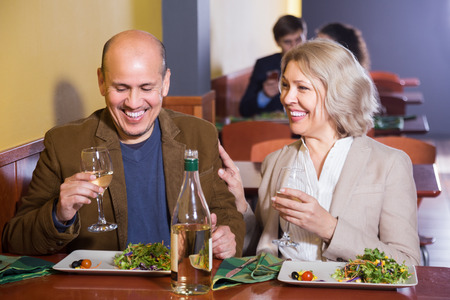Mature couple spending time together at restaurant tableの写真素材