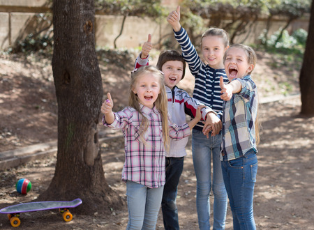 happy friendly kids at the park in autumnの写真素材