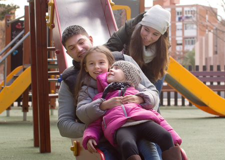 happy family playing at playground at Springの写真素材