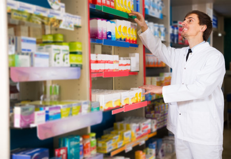 male pharmacists working in modern farmacyの写真素材