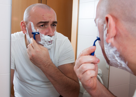 Man shaving in front a mirrorの写真素材