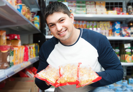 Male customer looking at assortment of pastaの写真素材