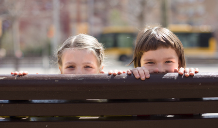 children look out of the back street bench in Indian summerの写真素材