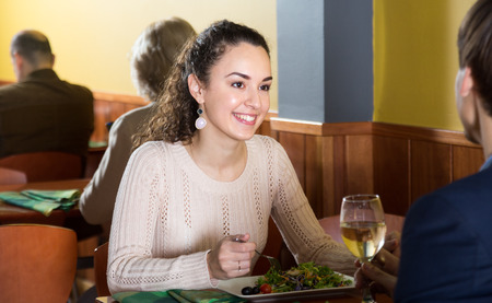 young woman having dinner with a man in a restaurantの写真素材