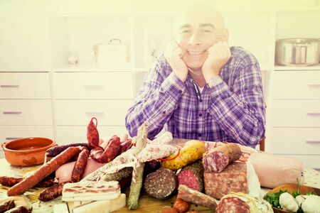 portrait of ordinary men with lots of meat and sausage productsの写真素材