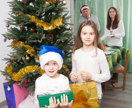 happy Children with gifts near a Christmas treeの写真素材