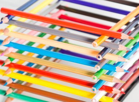 colored pencils stacked in log houseの写真素材