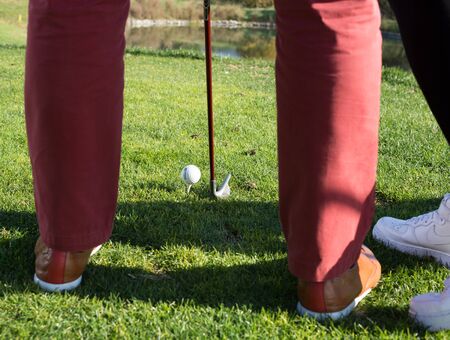 iron to ball and takes aim at the golf clubの写真素材