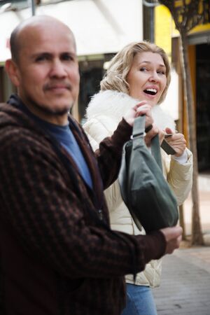 robber takes away the bag of a womanの写真素材